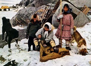 Eskimos woman working with a seal